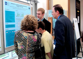 Andrew Zureick discusses his poster with visitors