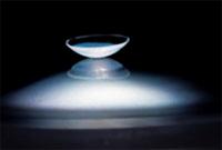 A child wearing a contact lens. A green dye is used to evaluate the fit of hard lenses. Credit: Dr. Scott Lambert, Emory.