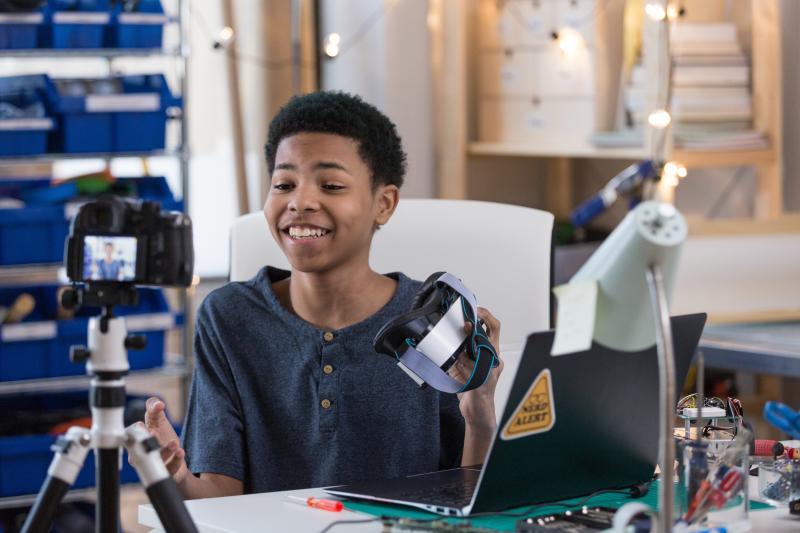 boy sitting in front of camera