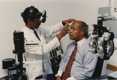 Eye doctor examining an older gentleman's eyes
