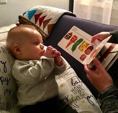 A baby looks at a book