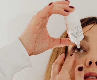 Woman using eyedrops