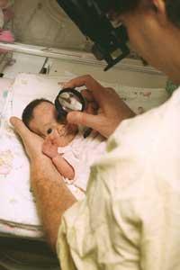 NICU care providers take photos of a premature baby's retinas in the NEI-funded e-ROP study of telemedicine for retinopathy of prematurity. Photo credit: Children's Hospital of Philadelphia 