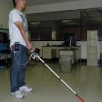 Man using robotic cane in an office