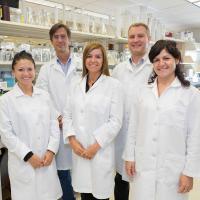 Group of 5 scientists in a laboratory.