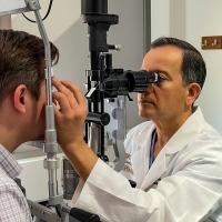 Rajendra Apte examining a patient's eye