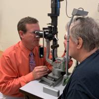 Patients in the trial were closely monitored for changes in vision, said Carl W. Baker, M.D. (left). During the 2-year study, the detection of 2 lines of visual acuity loss at one visit or 1 line of visual acuity loss at two consecutive visits prompted aflibercept injections to be given to the people in the laser or observation groups. Photo credit: Brooksie Beard