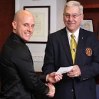 James W. Gollady, Jr., Right Eminent Department Commander (right), presents Hotaling with a check from the Knights Templar Eye Foundation. “I think this award is extremely important to pave a pathway for me in medical research,” said Hotaling.  (Joe Balintfy, NEI)