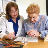 An occupational therapist at Thomas Jefferson University works with a patient who has low vision. Credit: Thomas Jefferson University.